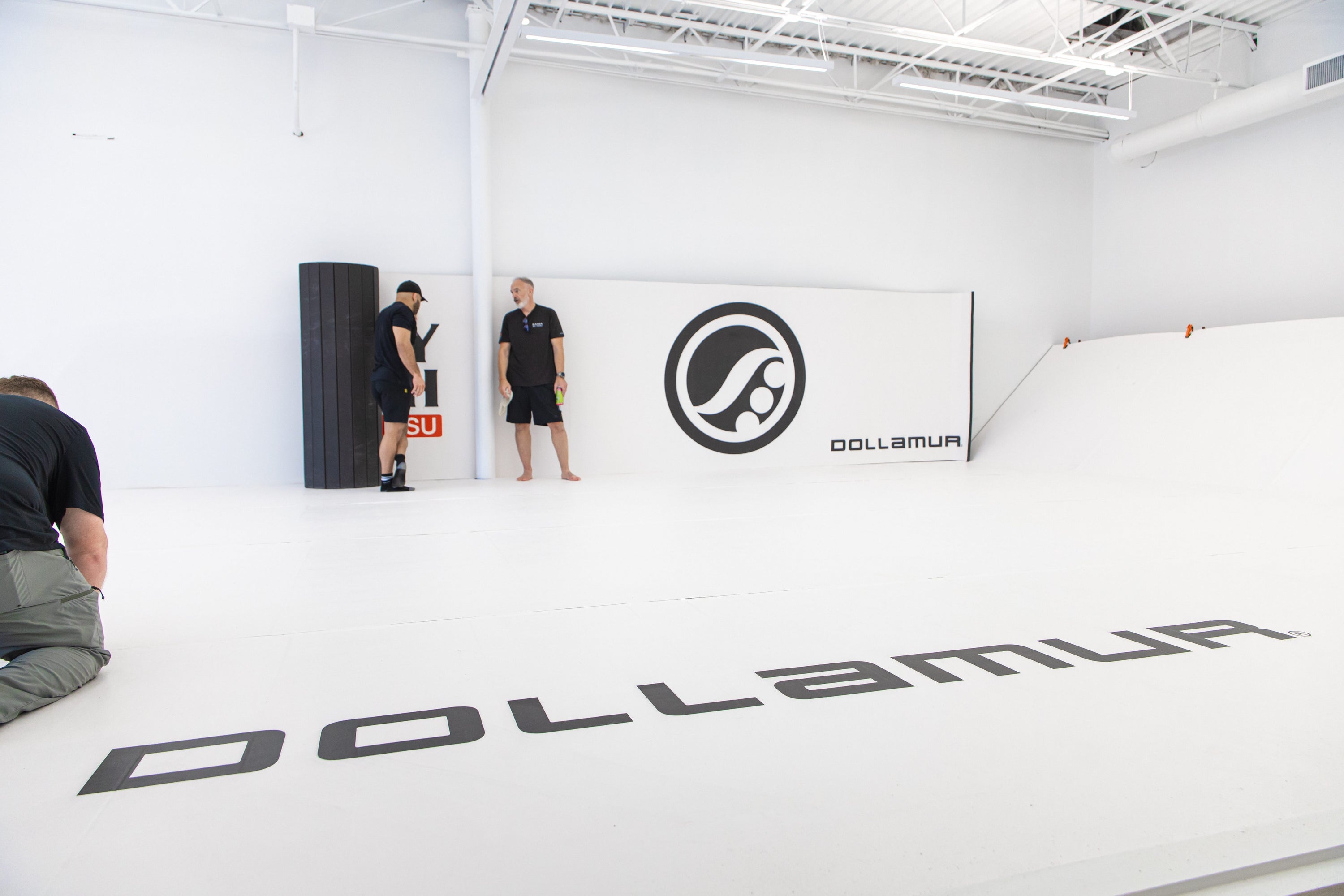 Gym wall padding in a commercial fitness facility showcasing safety and branded design