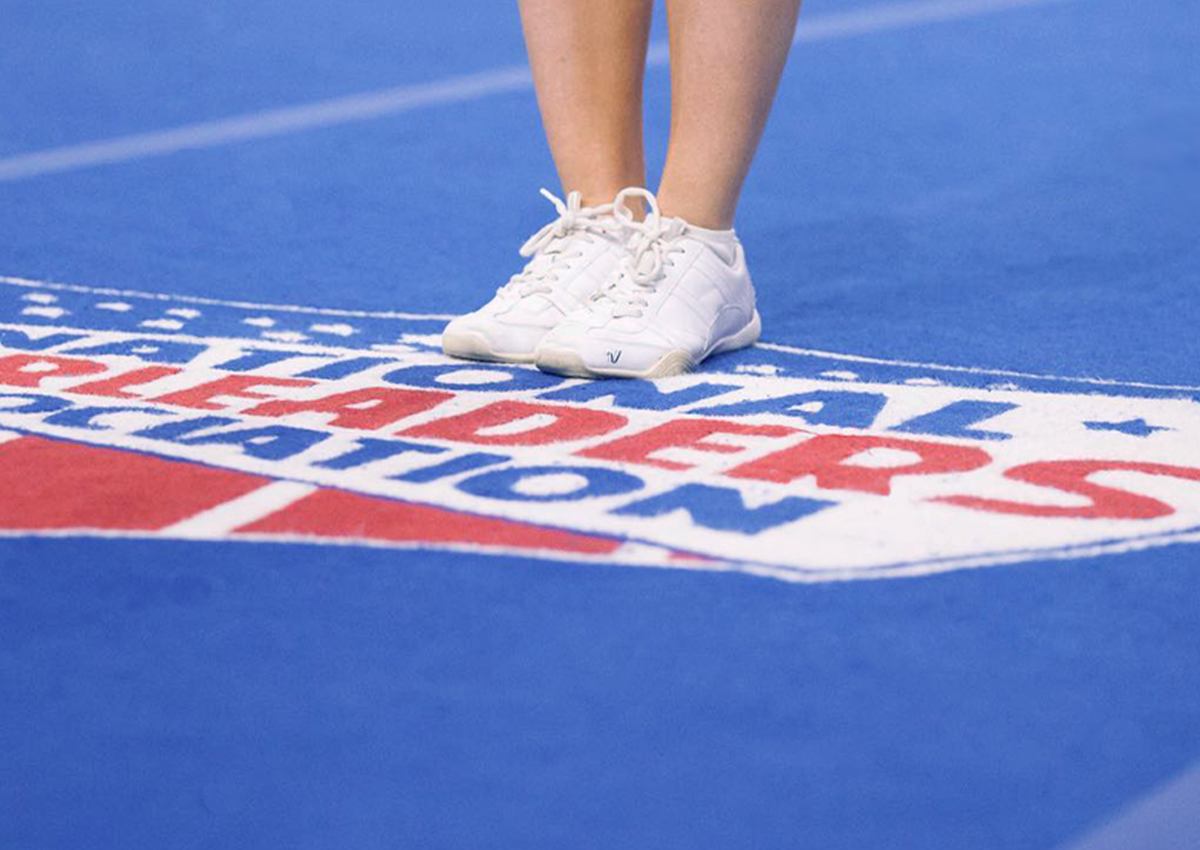 White sneakers on a blue Dollamur gymnastics mat