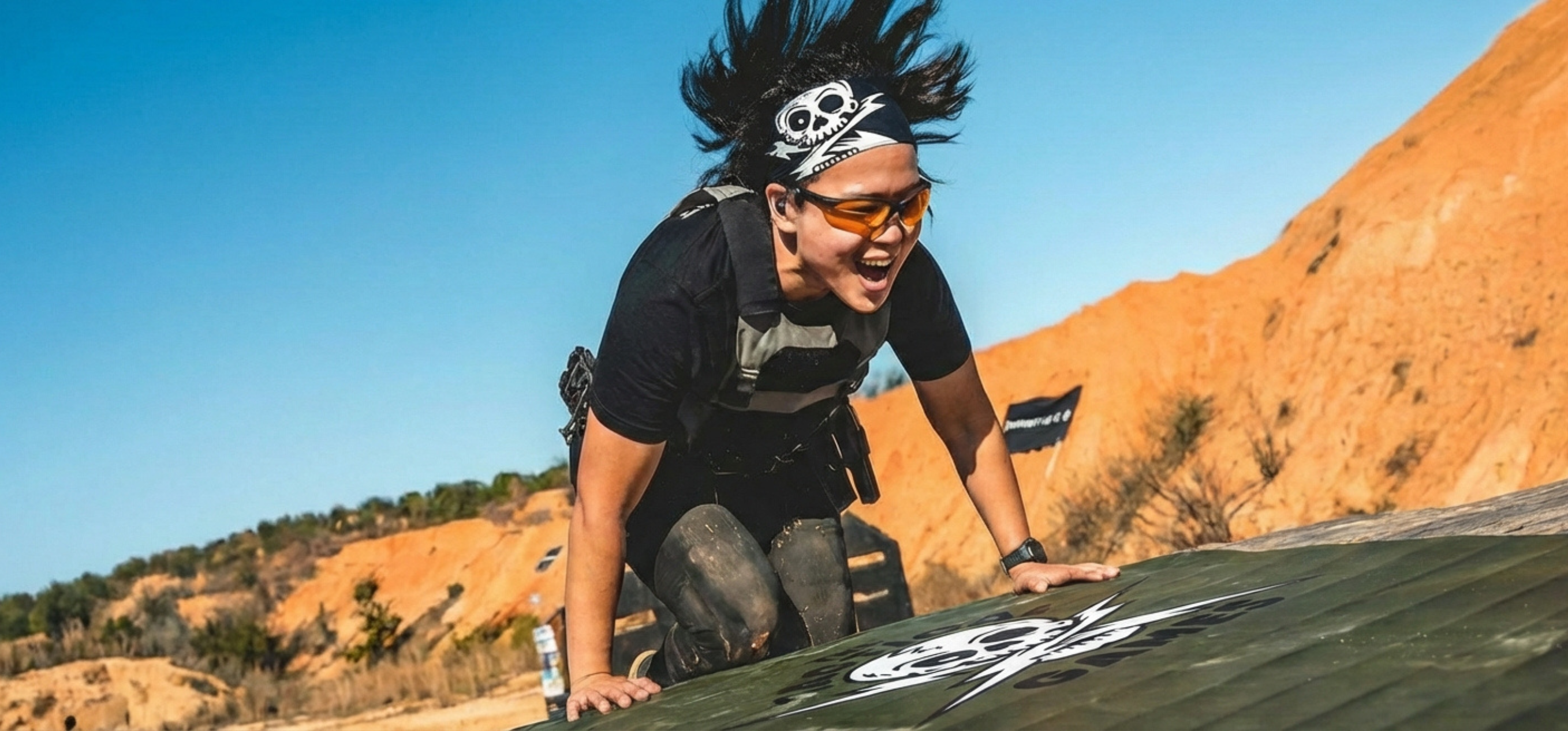 a female working out in the desert on a Dollamur military training mat