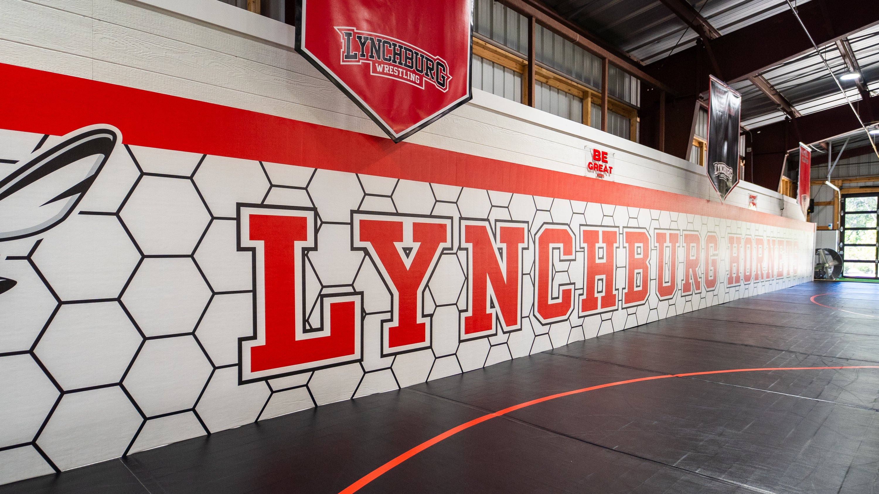 wall padding with 'Lynchburg' branding and logo in a sports facility.