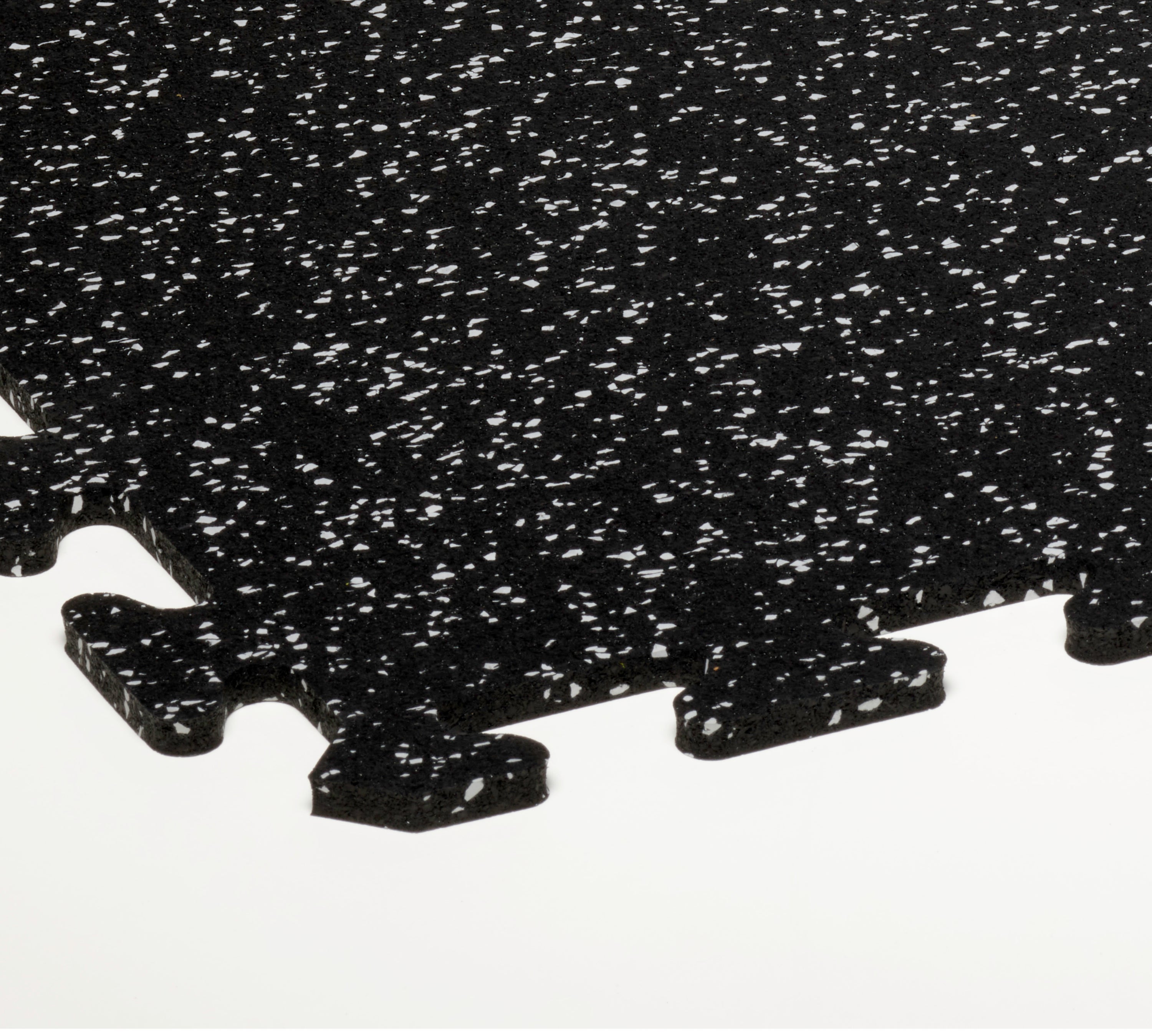 Black interlocking rubber gym tiles with white speckles on a white background