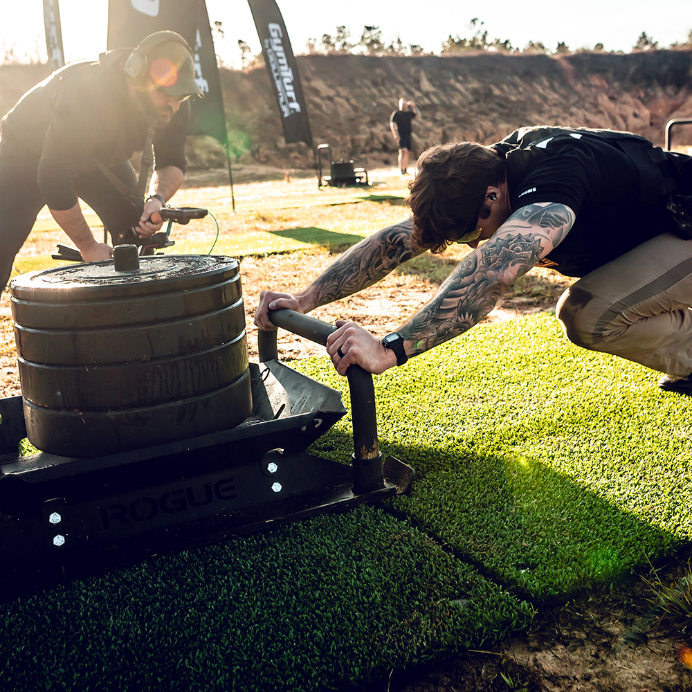 an athlete pushing heavy weight on GymTurf